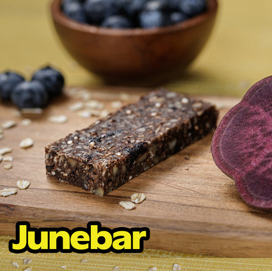 A photograph of a blueberry Junebar on a cutting board, looking yummy.