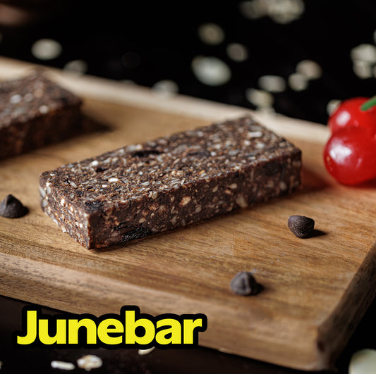 A photograph of a chocolate cherry junebar on a cutting board, looking yummy.