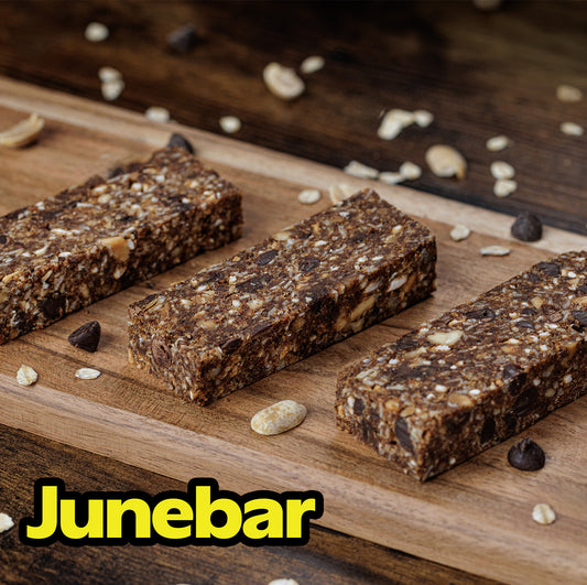 A photograph of 3 peanut butter chip Junebars on a cutting board, looking yummy.