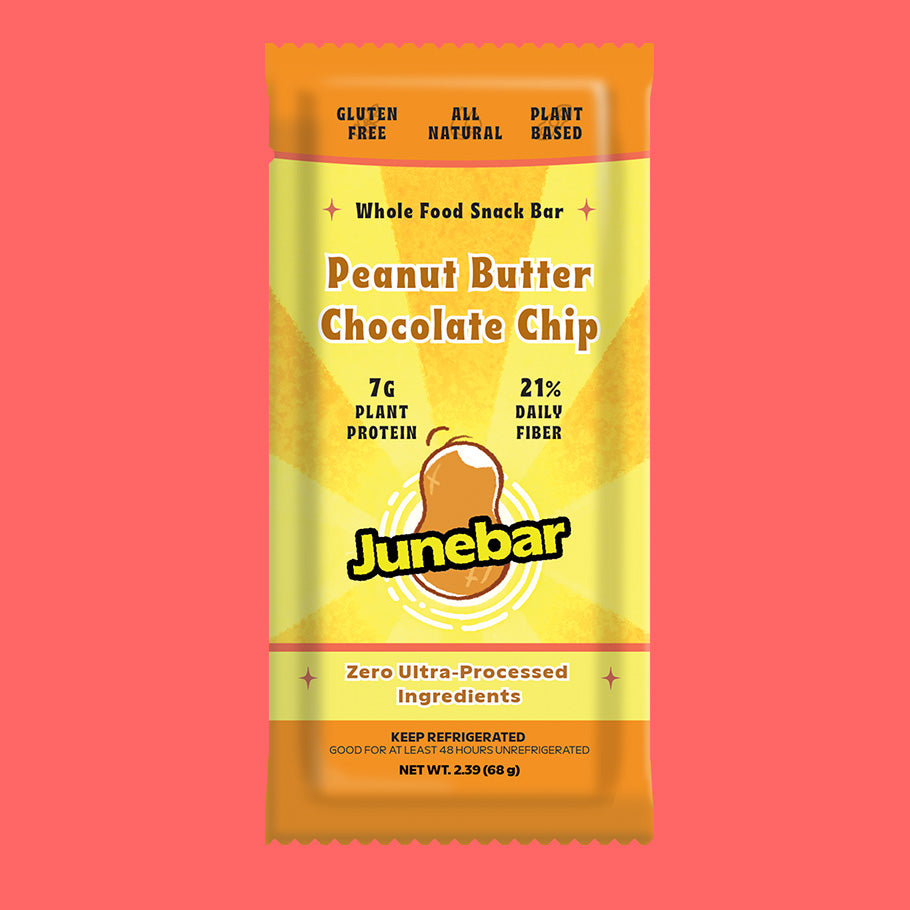 A single packaged Junebar snack bar on a solid coral pink background. The wrapper is yellow and orange with text reading 'Peanut Butter Chocolate Chip' and 'Whole Food Snack Bar,' plus Junebar branding and product claims.